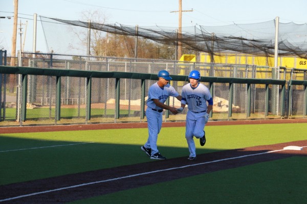 Coach Joey Latino congratulates Nick Ray as he rounds third base and heads for home. Against Ponchatoula in the fourth game of the WGNO Classic, Ray belted another leadoff solo home run.