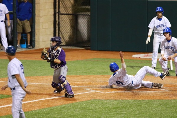Catcher Josh Schmidt slides safely to score the Jays' second run of the game. Moments before, Connor Maginnis (7) crossed the plate on Nick Ray's single.