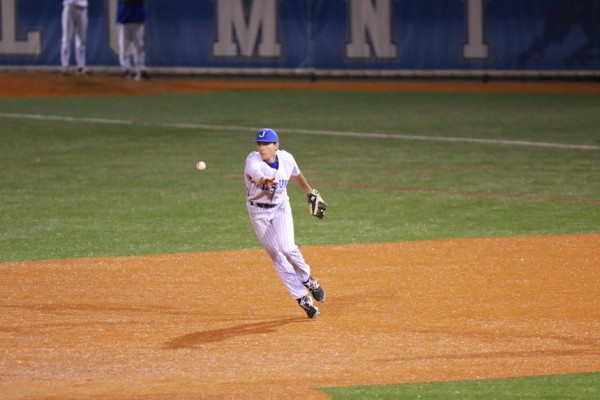 Second baseman Brandon Briuglio scoops a grounder and flips the ball to shortstop Nick Ray...