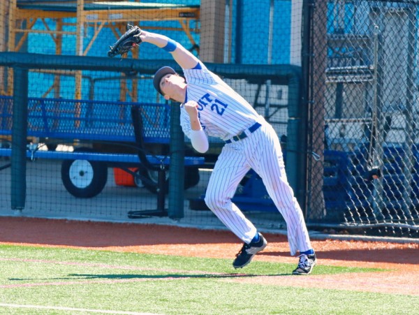 First baseman Jake Licciardi battles the sun to make a difficult catch of a pop foul.