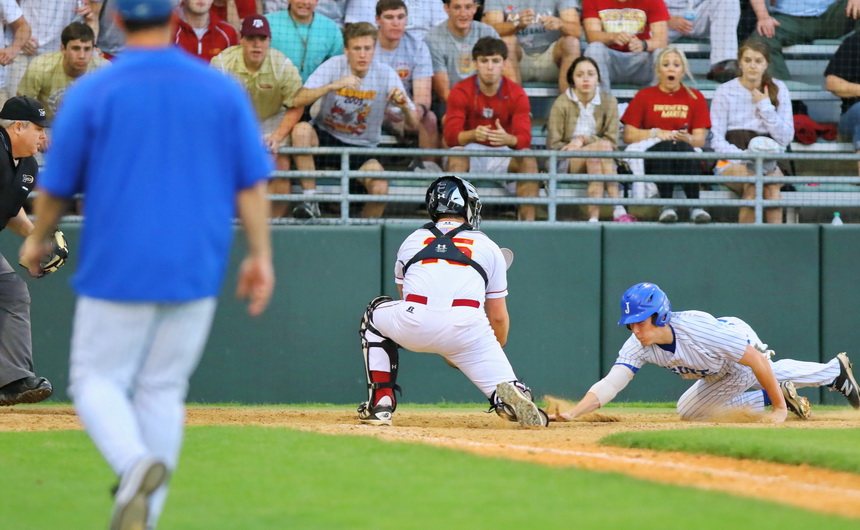 Hayden Fuentes attempts to score in the first inning of Jesuit's game against Brother Martin, played Tuesday, April 5, at Kirsch-Rooney Stadium.