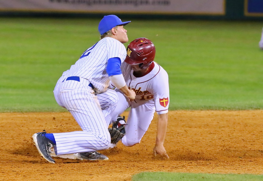 In the fifth inning, Nick Ray holds his ground and tags this Crusader who attempted to steal second base.
