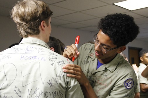 Gabriel Griffin signs his classmate's shirt.