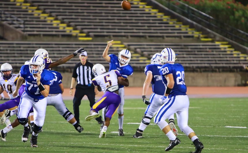 Quarterback Denny McGinnis floats a pass to Connor Prouet near the line of scrimmage. Prouet turned on the burners and sprinted 19 yards for one of his six touchdowns.