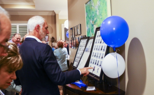 Rick Eigenbrod views photos of deceased classmates.