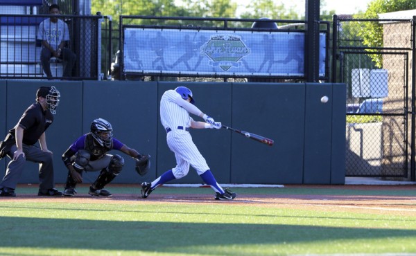 Senior Mark Theberge (3) adds to his RBI season tally by driving in Ray and Sepcich on this blast for a triple.