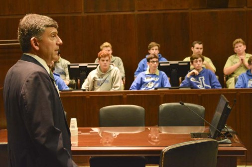 Jesuit teacher Greg Ernst '83 talks to students.