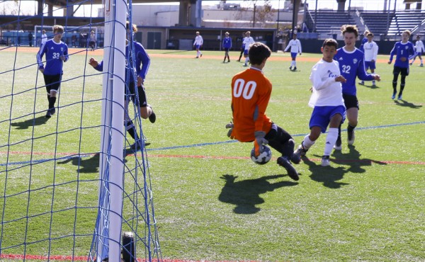 ...finesses the ball under the keeper,...