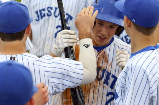 Players congratulate Matt Alexander on his home run.