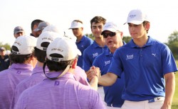 Junior Britton Khalaf, Jesuit's low man who placed T-7, leads the team in congratulating C.E. Byrd.