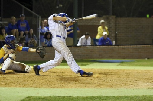 Senior Alex Watermeier follows through his 2-run home run swing in the top of the 12th inning.