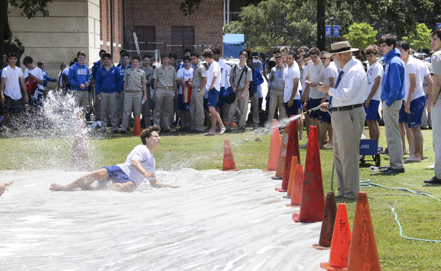 Senior Talon Comeaux gets hosed down as he takes his turn on the slip ‘n slide.